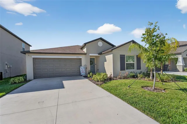 a front view of a house with a yard and garage