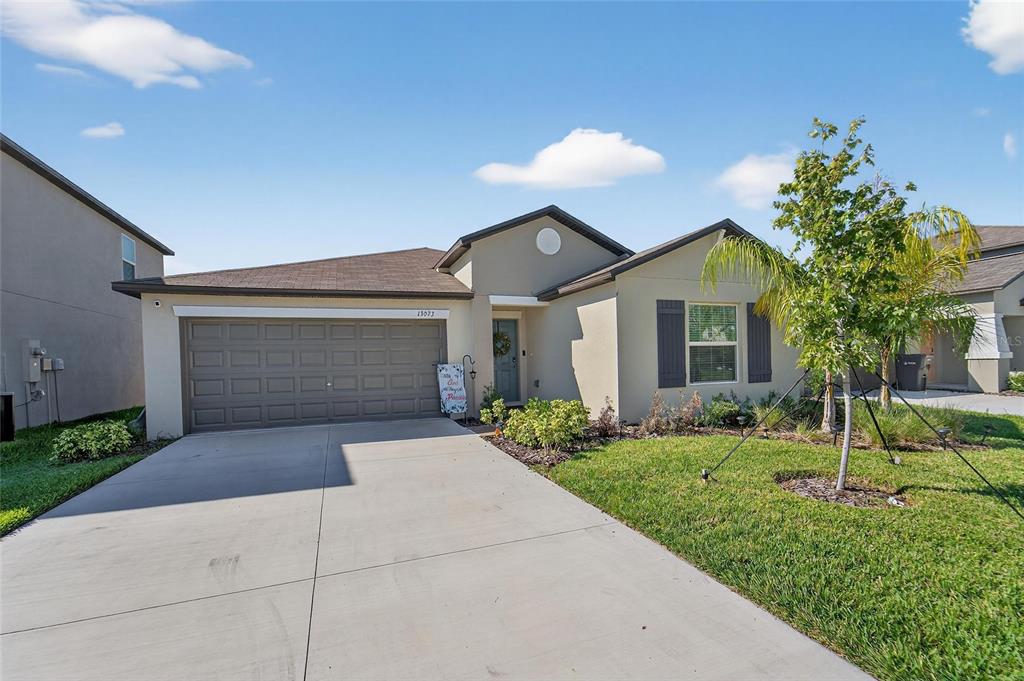 a front view of a house with a yard and garage