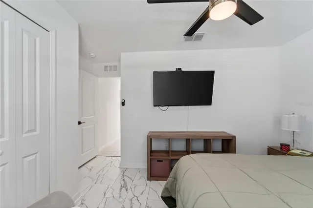 a bedroom with a bed and a flat screen tv