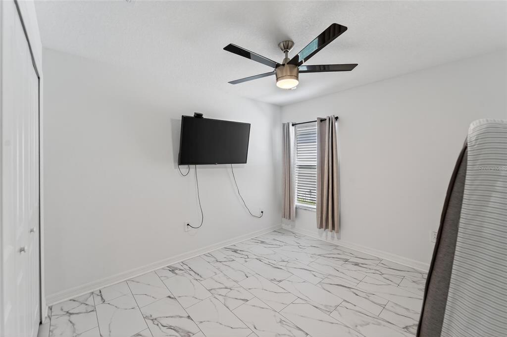 13073 Garnet Raspberry Avenue Wimauma, FL 33598 - Photo 18 of 50 a view of a livingroom with a flat screen tv