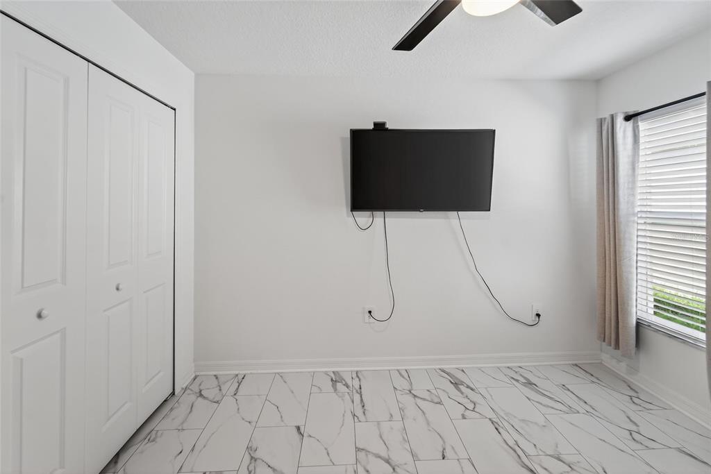 13073 Garnet Raspberry Avenue Wimauma, FL 33598 - Photo 19 of 50 a view of a room with gym equipment and a window