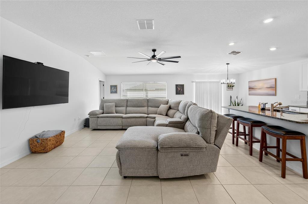 13073 Garnet Raspberry Avenue Wimauma, FL 33598 - Photo 22 of 50 a living room with furniture and a flat screen tv
