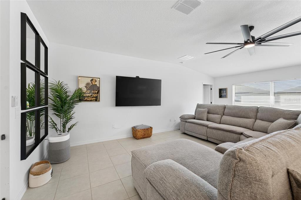 13073 Garnet Raspberry Avenue Wimauma, FL 33598 - Photo 23 of 50 a living room with furniture and a flat screen tv