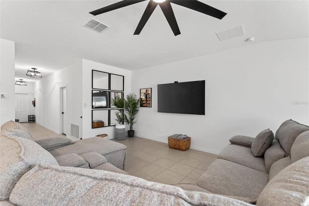13073 Garnet Raspberry Avenue Wimauma, FL 33598 - Photo 24 of 50 a living room with furniture and a flat screen tv