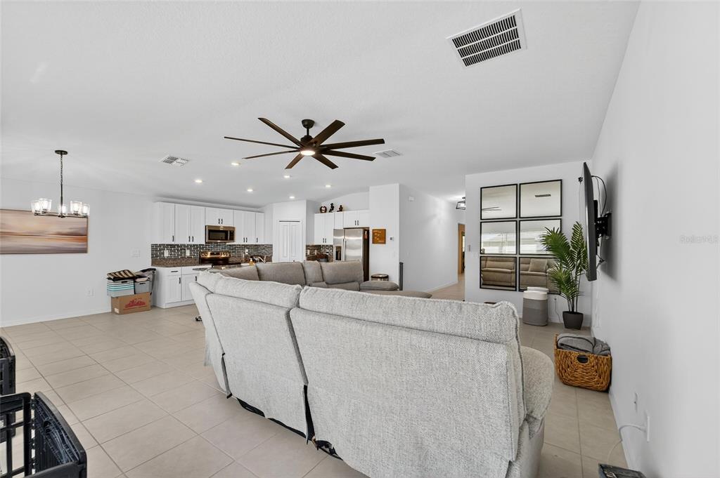 13073 Garnet Raspberry Avenue Wimauma, FL 33598 - Photo 25 of 50 a living room with furniture and a view of kitchen