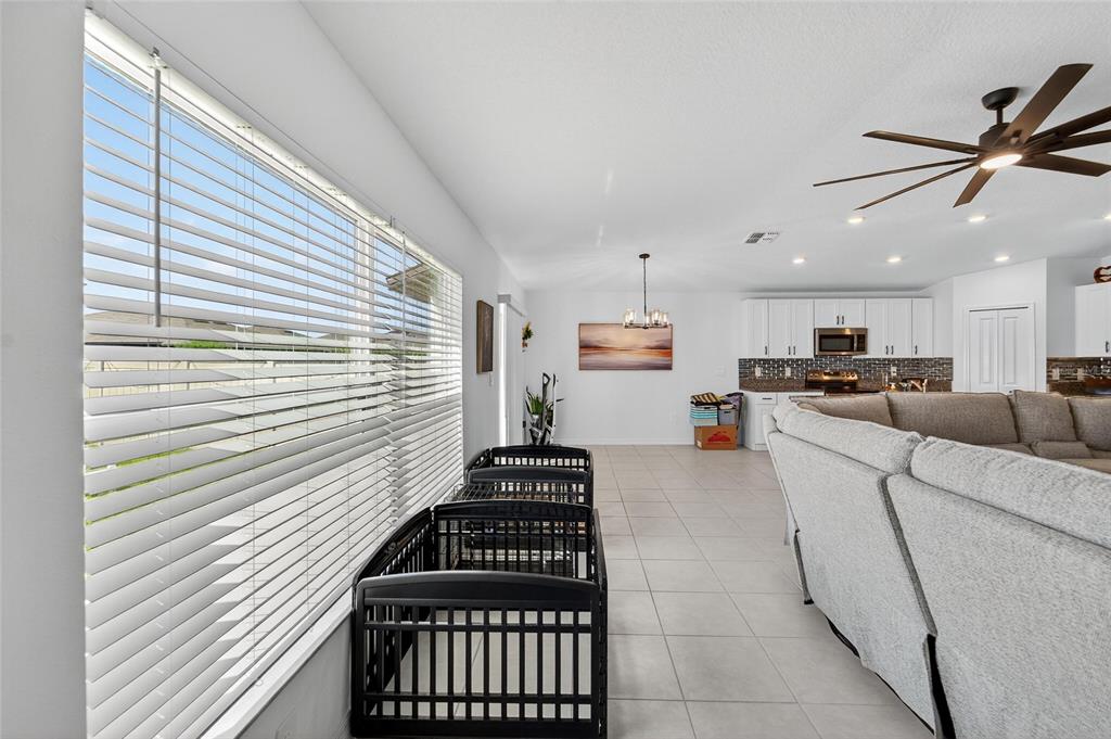 13073 Garnet Raspberry Avenue Wimauma, FL 33598 - Photo 26 of 50 a living room with furniture and kitchen view