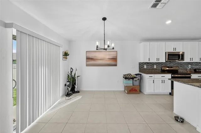 a kitchen with a refrigerator and a stove top oven