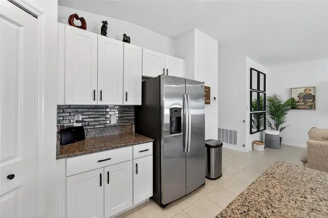 a kitchen with stainless steel appliances granite countertop a sink a stove and cabinets