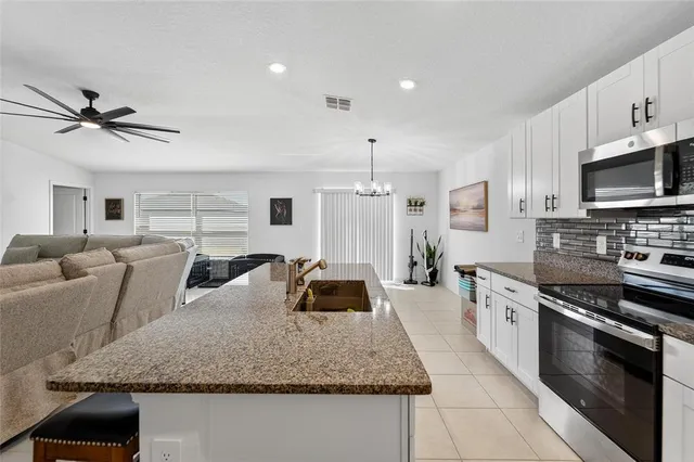 a bedroom with furniture and a chandelier