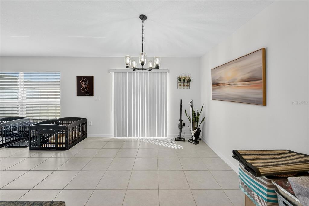 13073 Garnet Raspberry Avenue Wimauma, FL 33598 - Photo 34 of 50 a bedroom with furniture and a chandelier