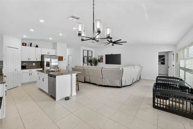 a bedroom with a bed and a ceiling fan