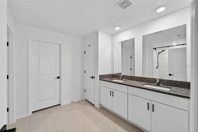 a bathroom with a glass shower door