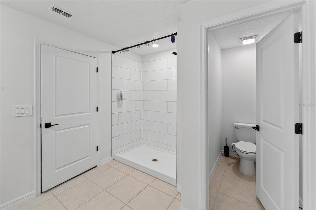13073 Garnet Raspberry Avenue Wimauma, FL 33598 - Photo 43 of 50 a bathroom with a shower and a toilet