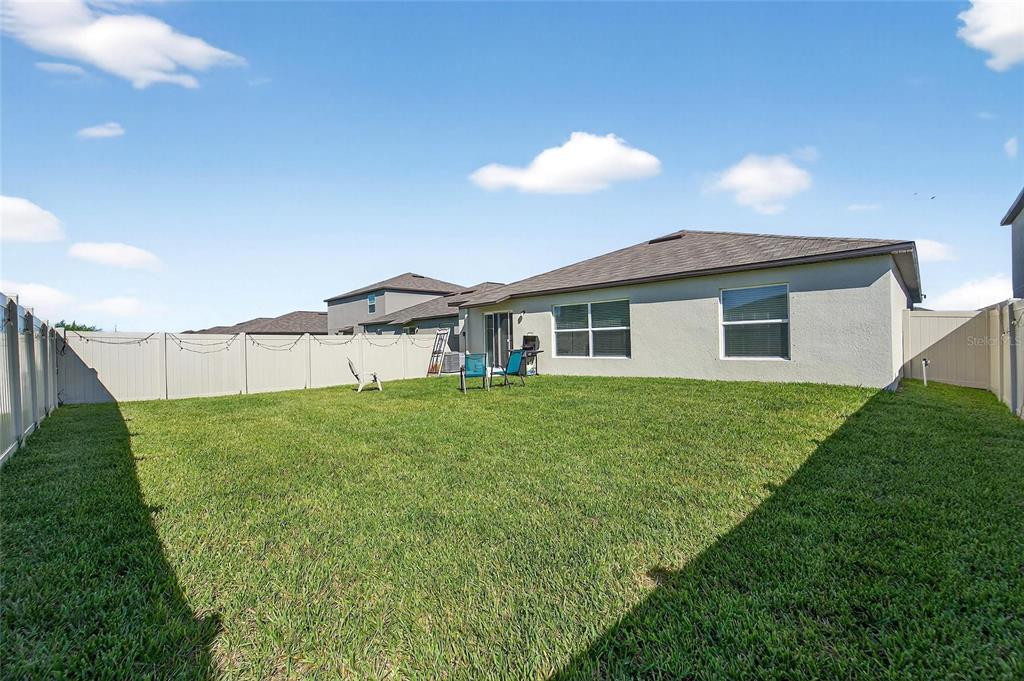 13073 Garnet Raspberry Avenue Wimauma, FL 33598 - Photo 48 of 50 a view of a backyard with plants and a garden