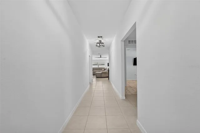 a view of a hallway with wooden shelves