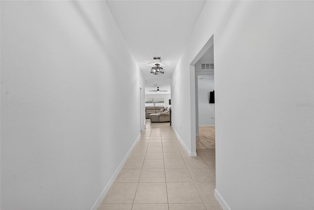 13073 Garnet Raspberry Avenue Wimauma, FL 33598 - Photo 6 of 50 a view of a hallway with wooden shelves