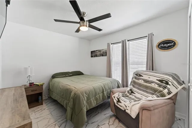 a bedroom with a bed and a window