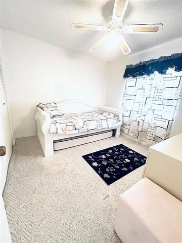 a kitchen with a stove a window and white cabinets