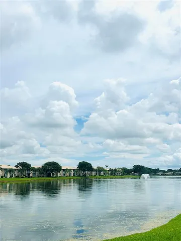 a view of a lake with houses in the back