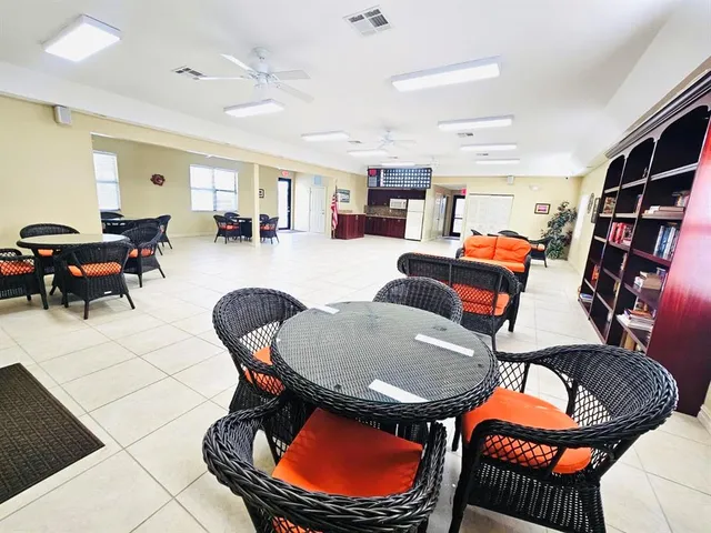 a living room with furniture a rug and a bookshelf