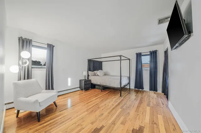 a bedroom with a bed and flat screen tv
