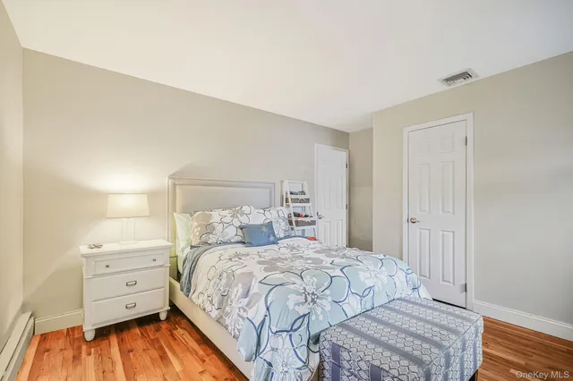 a bedroom with a bed and a mirror