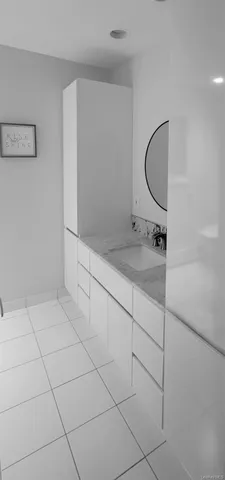 a bathroom with a sink vanity and mirror