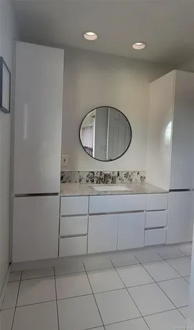 a bathroom with a toilet a sink and a mirror