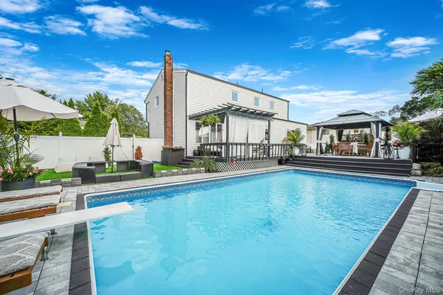 a view of house with swimming pool outdoor seating