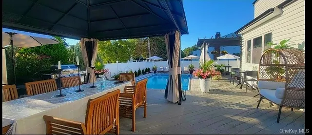 a balcony with chairs and a table