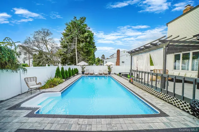 a view of swimming pool with seating area