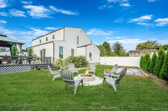a view of a patio with table and chairs potted plants with large tree
