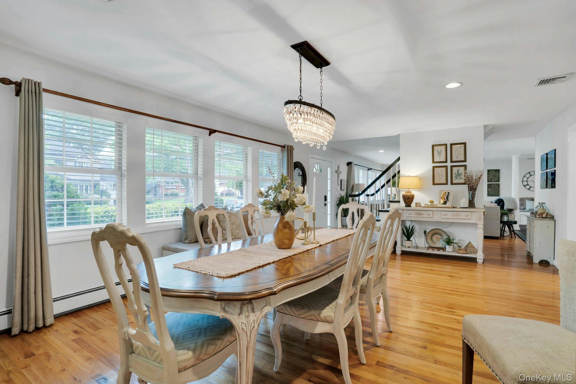 12 Rachel Avenue Commack, NY 11725 - Photo 11 of 50 a dining room with furniture a chandelier and wooden floor