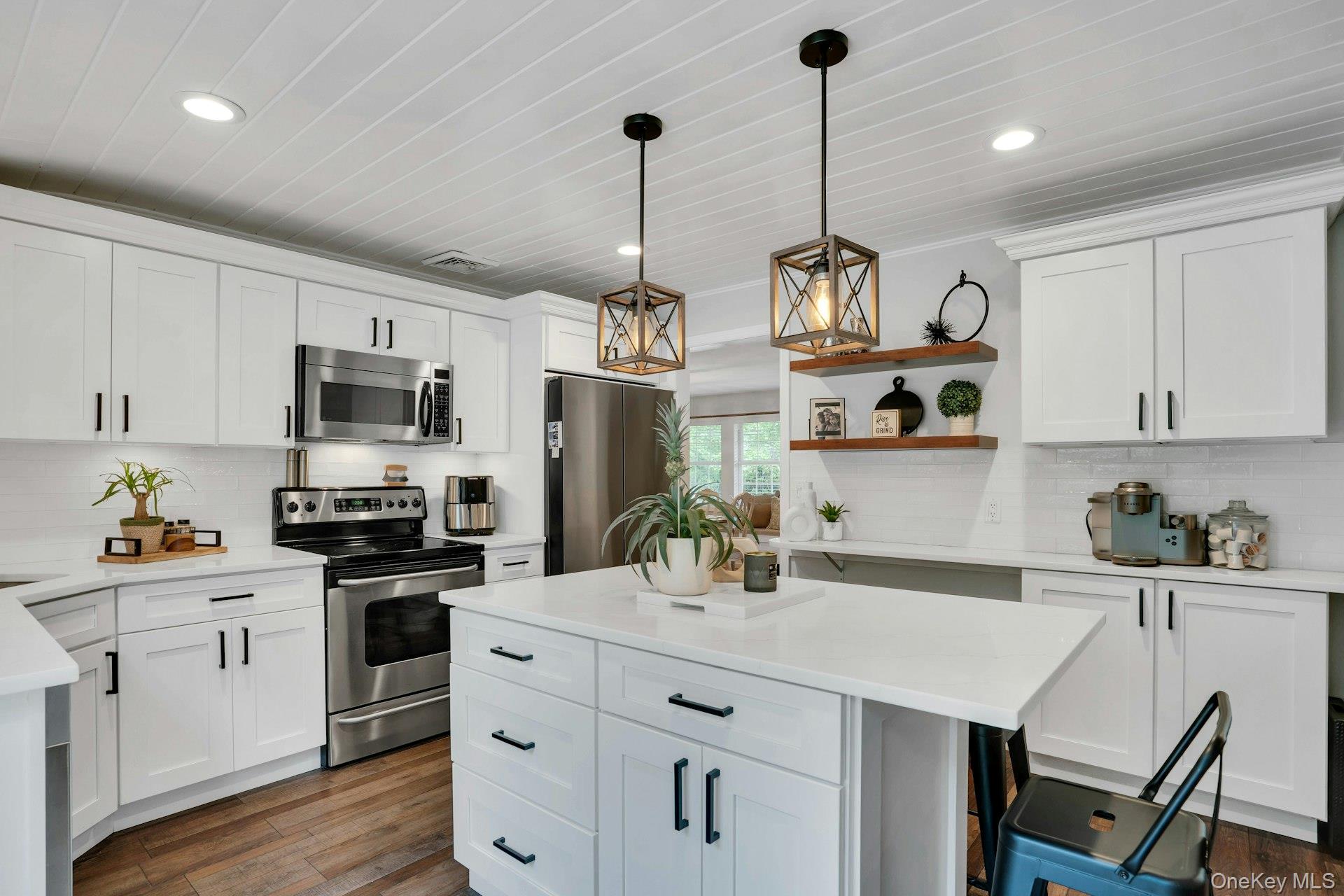 12 Rachel Avenue Commack, NY 11725 - Photo 21 of 50 a kitchen with stainless steel appliances kitchen island granite countertop a sink dishwasher a stove a refrigerator and cabinets with wooden floor