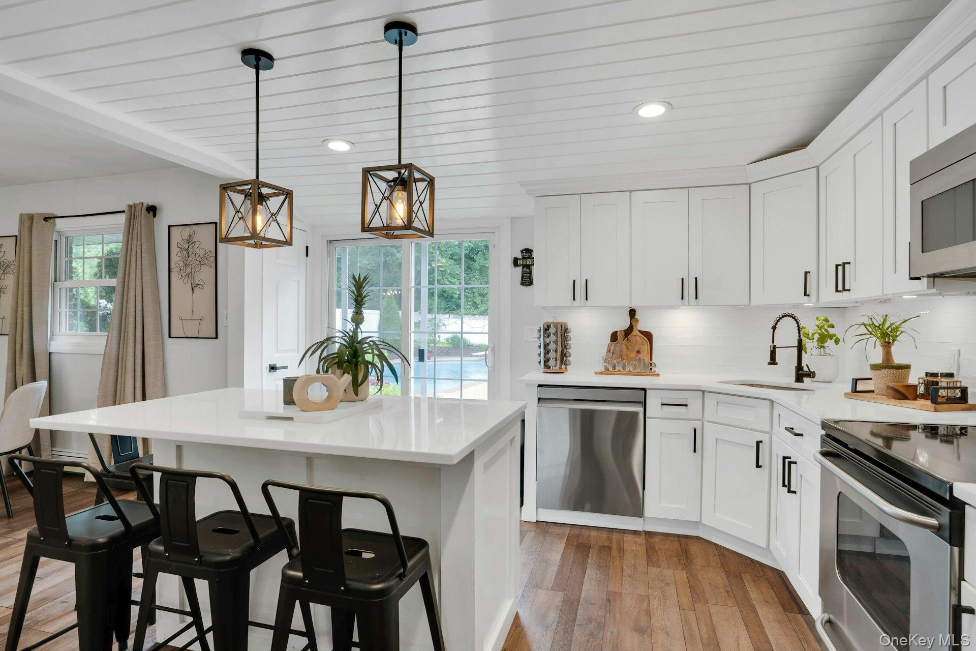 12 Rachel Avenue Commack, NY 11725 - Photo 23 of 50 a kitchen that has a table chairs appliances and cabinets