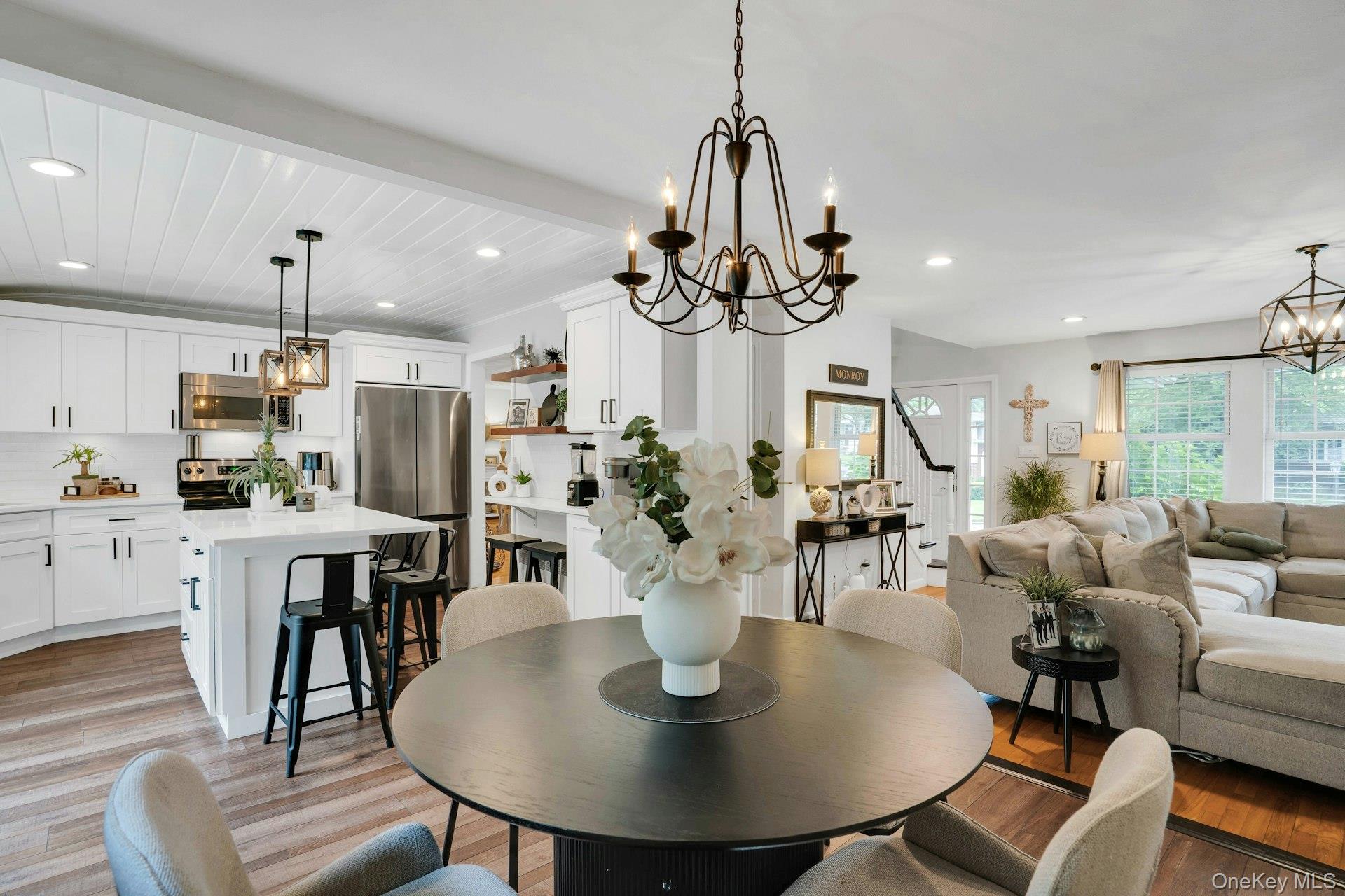 12 Rachel Avenue Commack, NY 11725 - Photo 27 of 50 a view of a dining room and livingroom with furniture wooden floor a chandelier