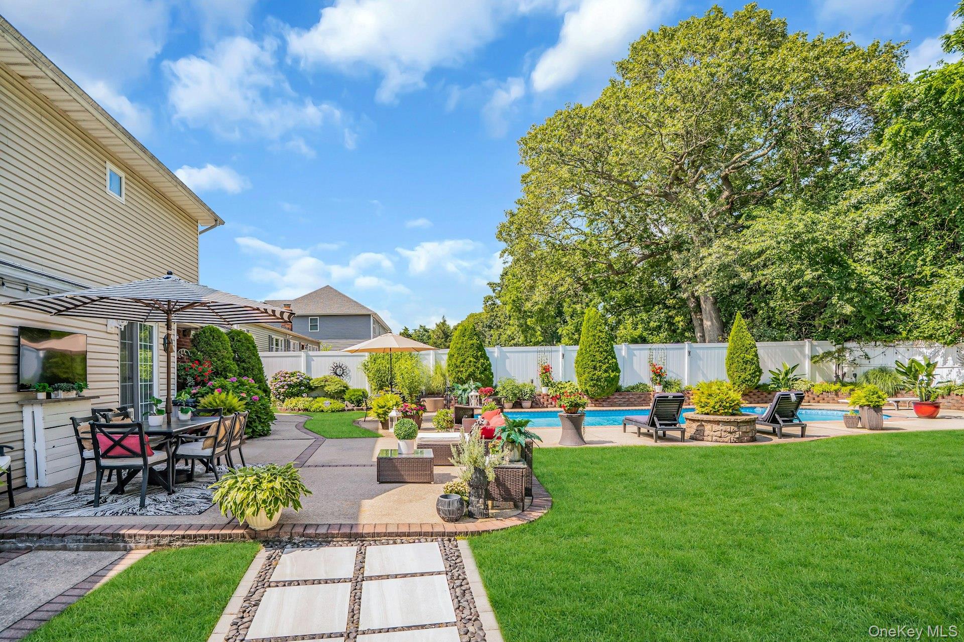 12 Rachel Avenue Commack, NY 11725 - Photo 38 of 50 a view of a house with a backyard porch and sitting area