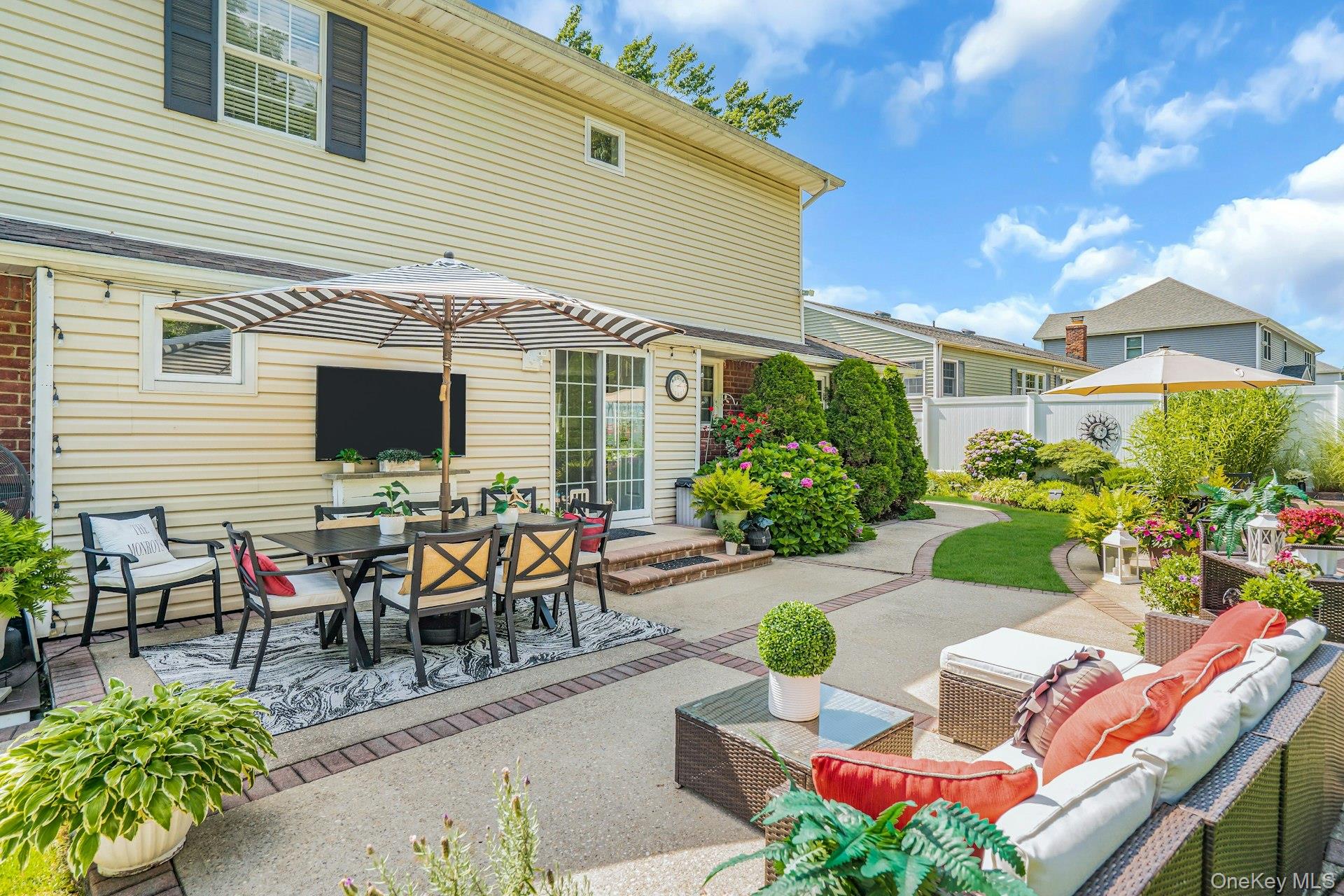 12 Rachel Avenue Commack, NY 11725 - Photo 46 of 50 a view of a patio with table and chairs and potted plants