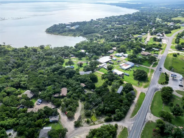 an aerial view of a houses with yard