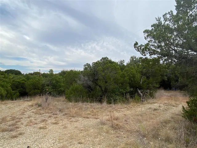 a couple of table and chairs under an umbrella