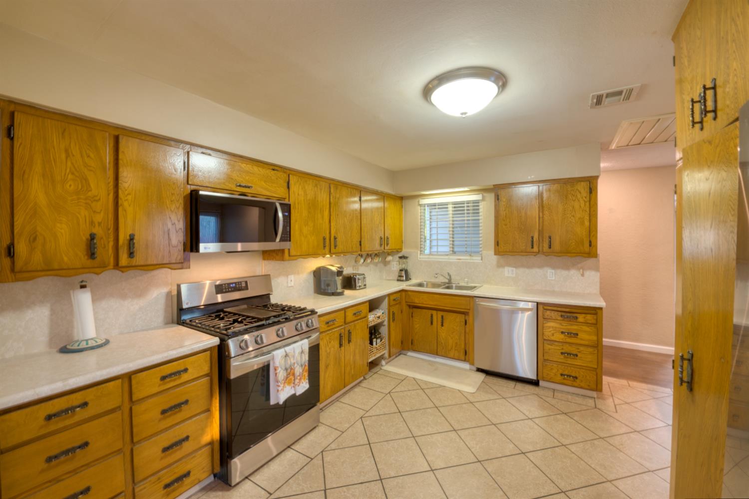 902 Waller Street Gustine, CA 95322 - Photo 11 of 32 a kitchen with stainless steel appliances granite countertop a stove and a sink