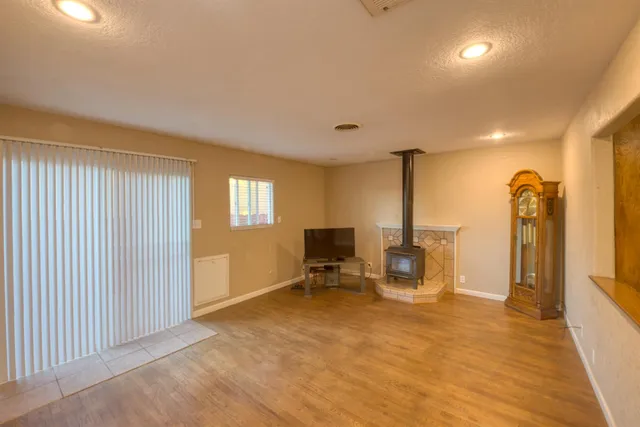 a view of a livingroom with wooden floor and a ceiling fan