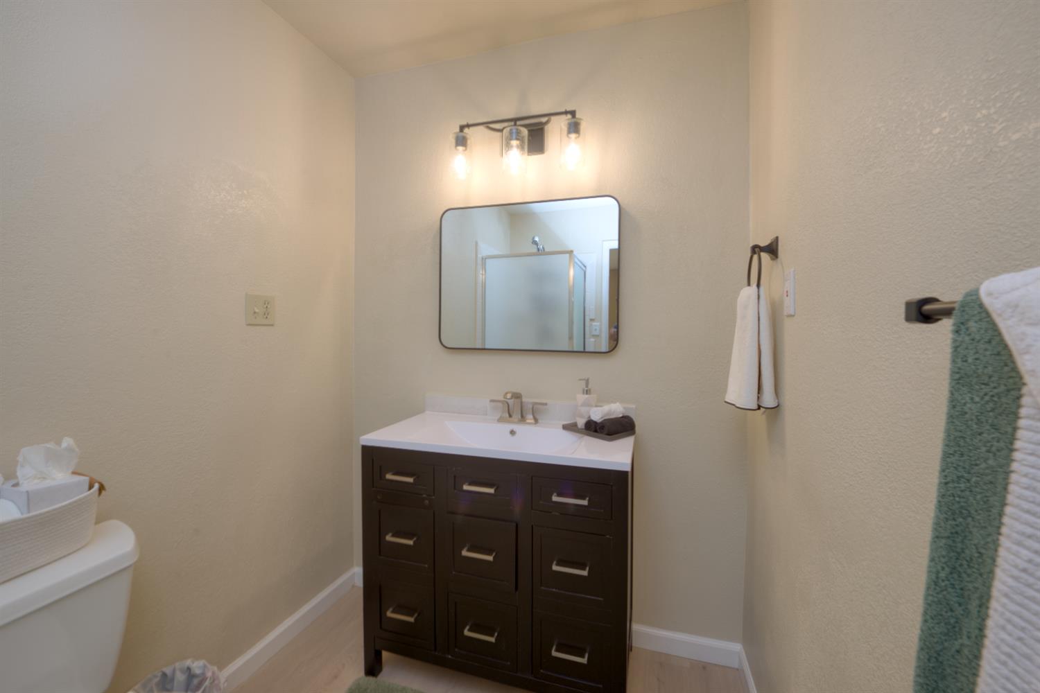 902 Waller Street Gustine, CA 95322 - Photo 20 of 32 a bathroom with a toilet sink and mirror
