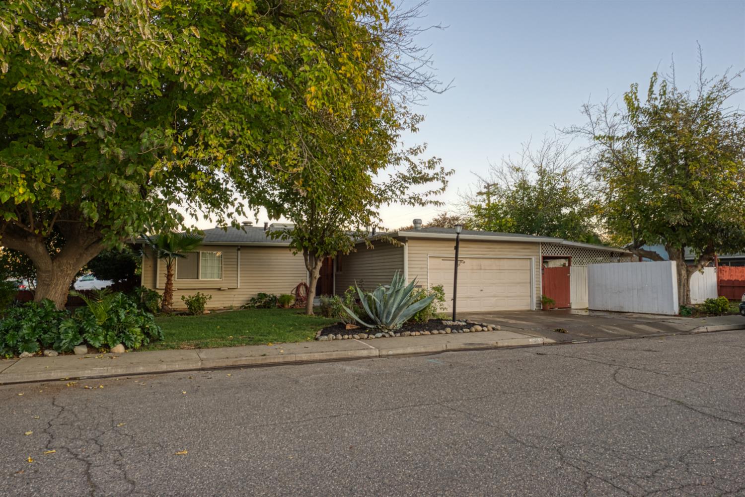 902 Waller Street Gustine, CA 95322 - Photo 2 of 32 a view of a house with a yard and garage