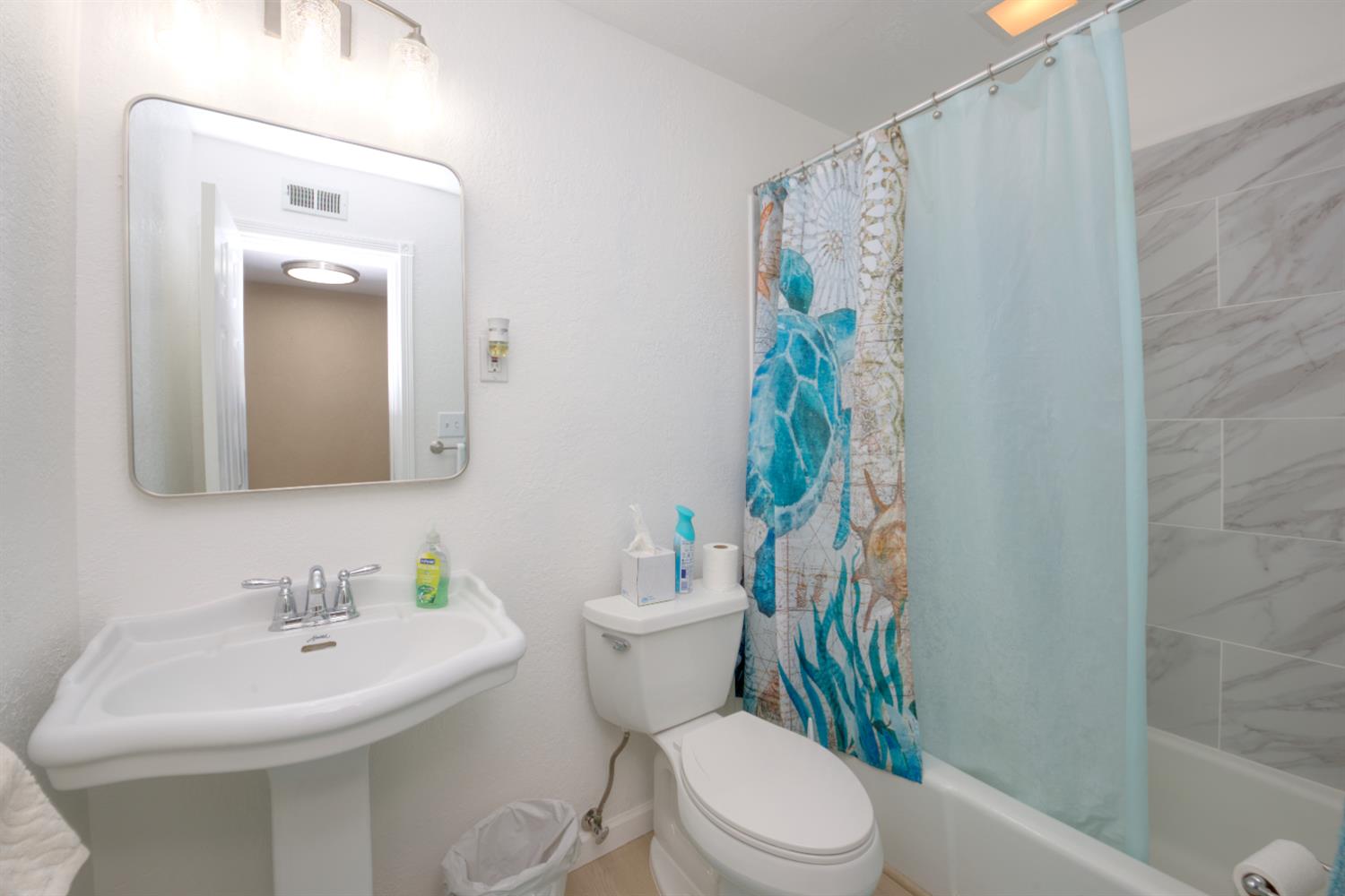 902 Waller Street Gustine, CA 95322 - Photo 21 of 32 a bathroom with a sink a toilet and shower curtain