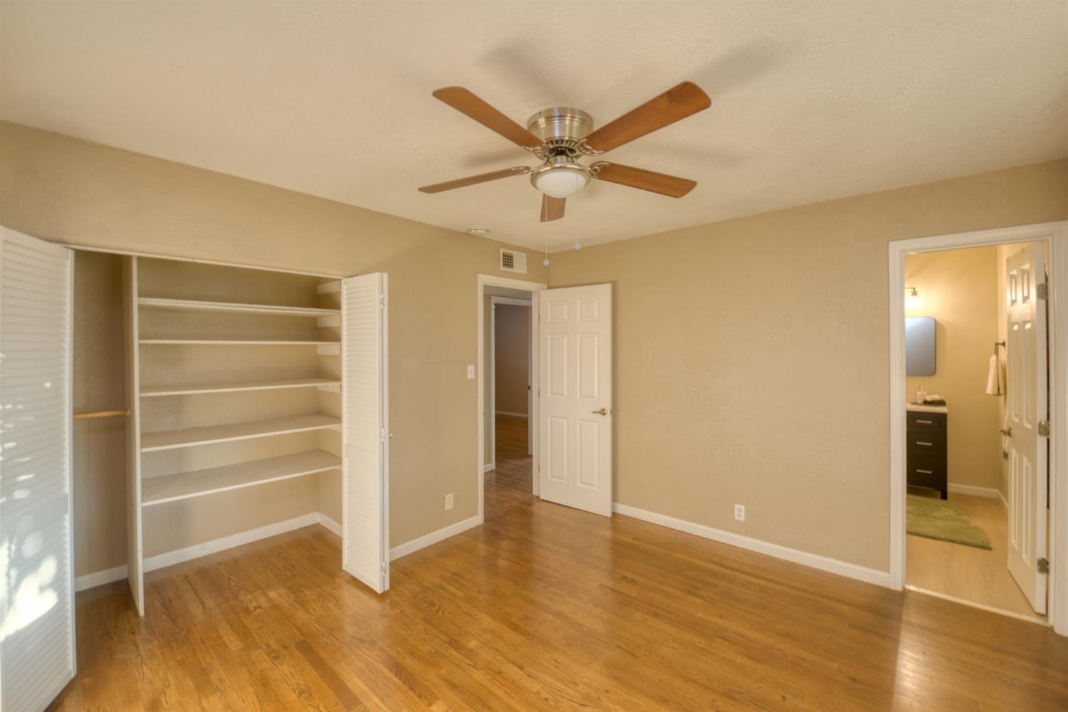 902 Waller Street Gustine, CA 95322 - Photo 23 of 32 a view of an empty room with wooden floor and a window