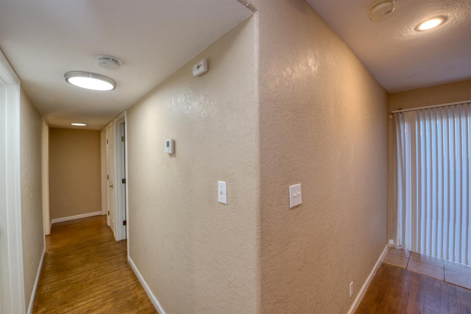 902 Waller Street Gustine, CA 95322 - Photo 25 of 32 a view of a hallway with wooden floor