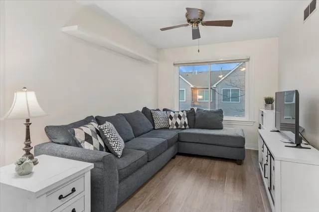 a living room with furniture and a book shelf