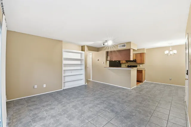 a view of a kitchen with an empty space and a window