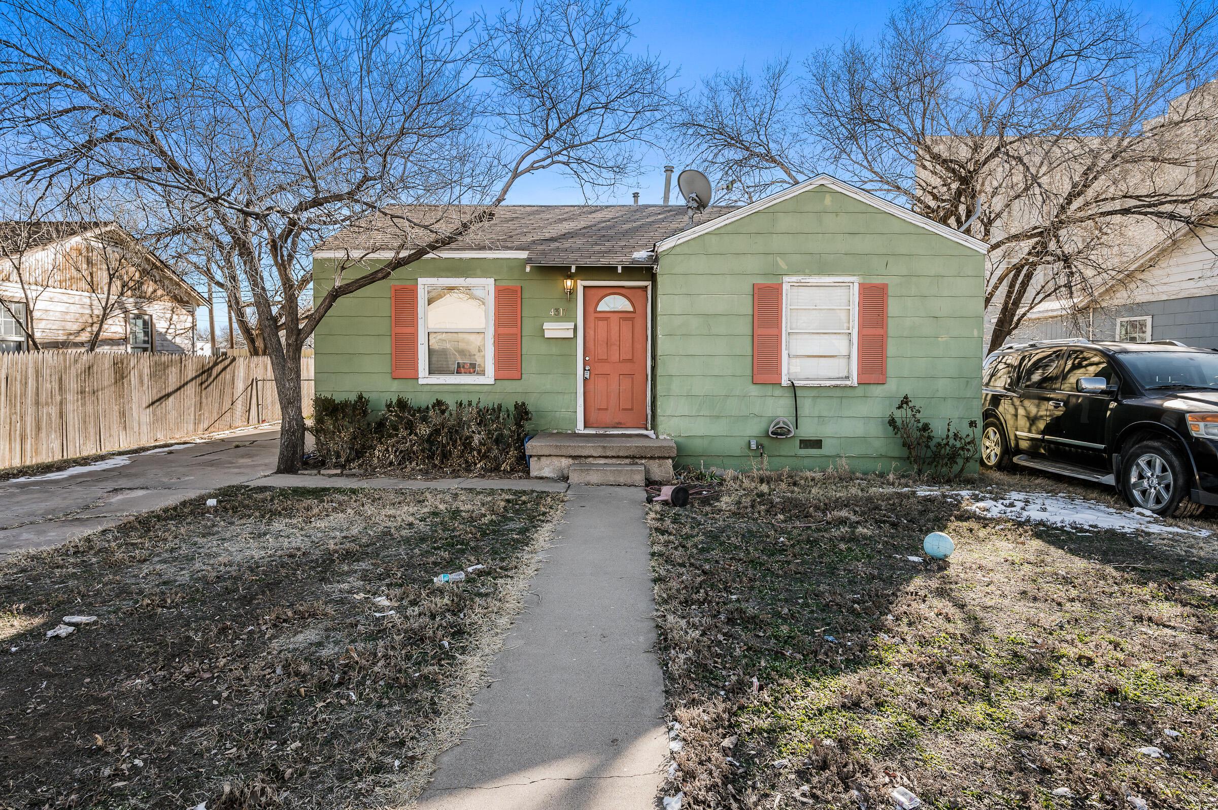 4317 South Polk Street Amarillo, TX 79110 - Photo 1 of 13 a front view of a house with a yard and garage